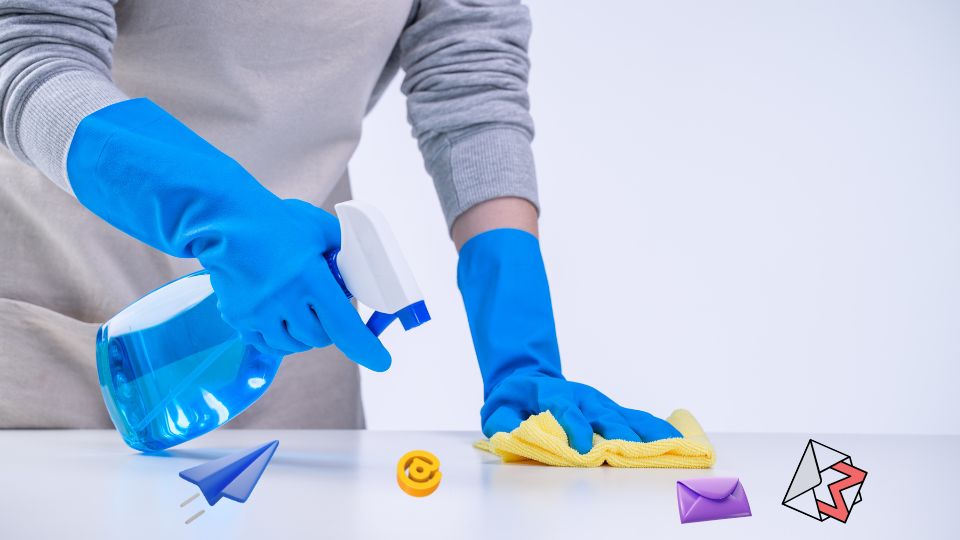 A person cleaning a surface surrounded by email icons, illustrating email list hygiene.